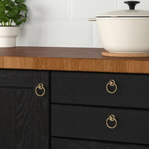 IKEA EDVALLA Brass cabinet knob being installed on a kitchen drawer, highlighting its stylish appearance -pack of 2 - 80347889