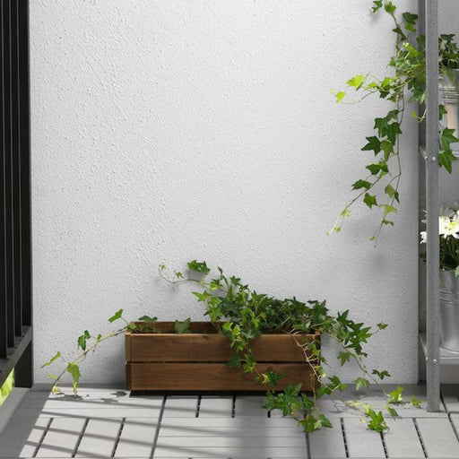 Outdoor Acacia Planter: A stylish wooden planter for outdoor spaces.