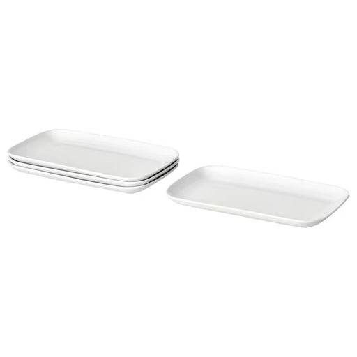 A stack of four IKEA GODMIDDAG white rectangular plates with slightly rounded corners, neatly arranged in a pile.