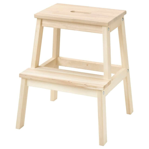 IKEA step stool with various household items on it, showcasing its practical use in home organization.