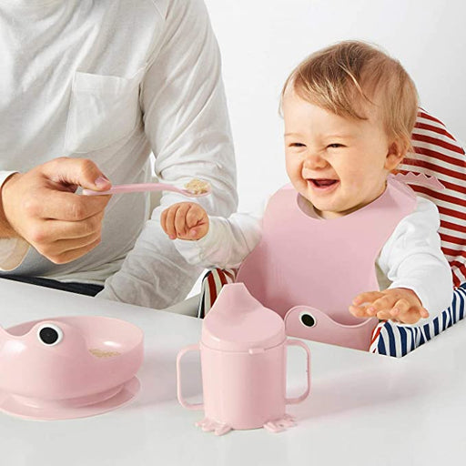 A top-down view of the IKEA 4-piece eating set, featuring a dinner plate, side plate, bowl, and mug arranged neatly on a dining table.