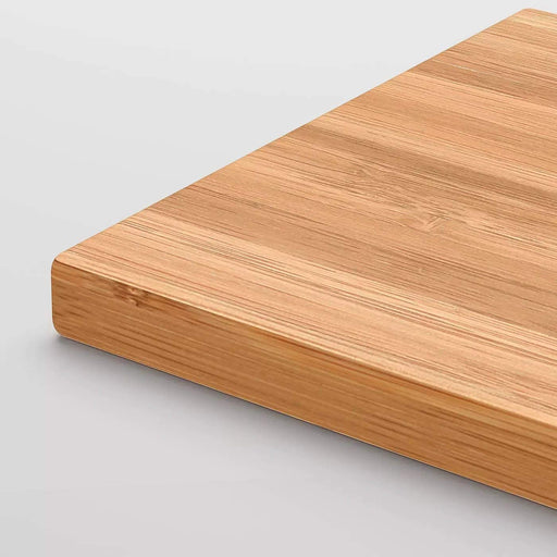 An IKEA bamboo chopping board featuring a smooth surface and a handle for easy carrying-20233428