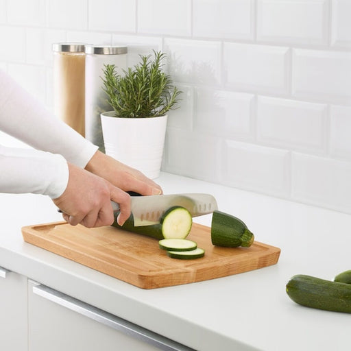 A chef's essential tool, an IKEA bamboo chopping board in a large size for heavy-duty use.