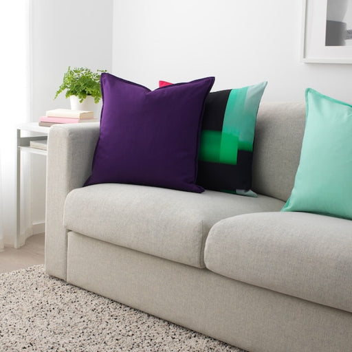 Multiple IKEA cushion covers in different colors and designs on a sofa-80443782