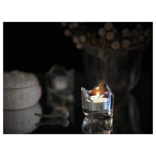  IKEA Wax Tealight Candle placed in a white porcelain holder, offering a minimalist and elegant touch to any room.